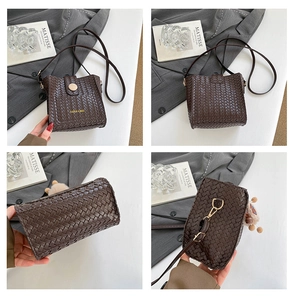 Detail view of a dark brown woven bucket bag with gold clasp and plush charm accessory