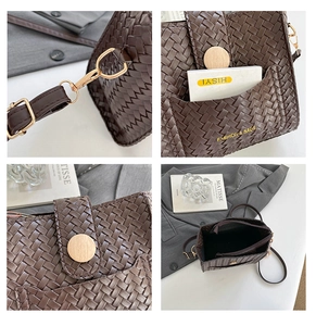 Detail of dark brown woven texture handbag with golden hardware and round wooden buckle