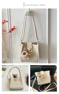 Detailed view of white woven texture shoulder bag with decorative wooden buckle and charm