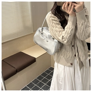 Metallic silver shoulder bag featuring a sleek rectangular shape and a delicate bow detail