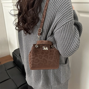 Fashionable leopard print crossbody bag with gold metal lock and adjustable shoulder strap