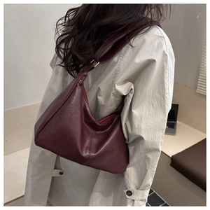 Rear view of a burgundy retro PU leather shoulder bag with glossy finish and soft strap