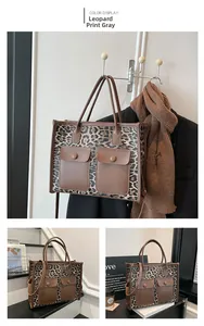 Detail view of the gray leopard print tote bag with brown straps and snap pockets