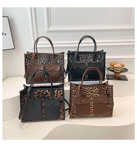 Macro display of four leopard print tote bags with front flap pockets and leather handles