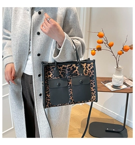 Detail of leopard print tote bag with double front snap pockets and black handles