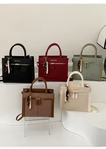 Detailed display of vintage square handbags in five colors with beaded tassels