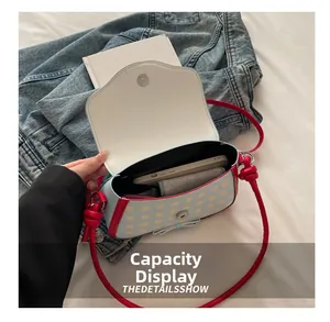 Detail showing the internal capacity of the blue checkered crossbody bag for daily items