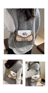 Detail showing the polka dot flap, orange plaid side, and 3D bow on the crossbody bag
