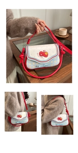 Detail view of contrast color crossbody bag with apple embroidery and blue plaid pattern