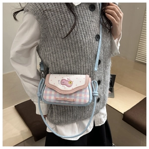 Detail of pink bow and cartoon embroidery on plaid apple crossbody bag for women