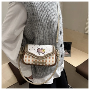 Detail of checkered crossbody bag featuring a cute bow and cartoon flap design
