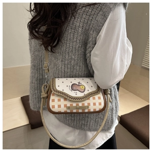 Detail view of pink apple crossbody bag featuring polka dots, embroidery and bow detail