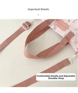 Detail of pink tie-dye tote bag with adjustable shoulder strap and leather logo tag