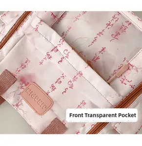 Detail of pink crossbody bag featuring transparent front pocket and Chinese calligraphy print