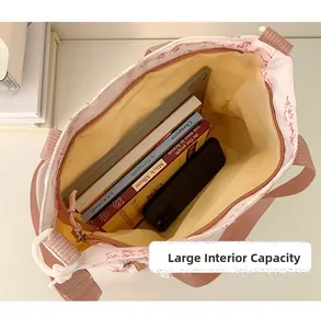 Top view of spacious pink calligraphy tote bag interior with tablet and books