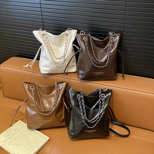 Minimalist glossy patent leather bucket bags with silver chain straps in four colors