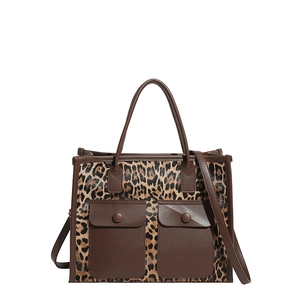 Large leopard print tote bag with brown leather pockets and a detachable shoulder strap