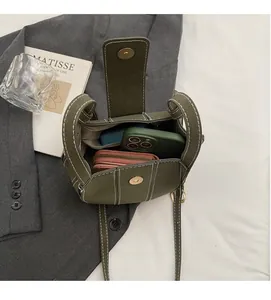 Detail view of the green bucket bag interior with contrast stitching and ample space