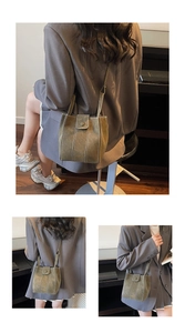 Macro detail of olive green bucket bag featuring white contrast stitching and matte texture