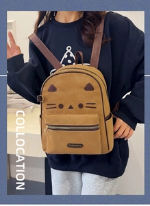 Brown cat-themed backpack featuring embroidered whiskers and ears in a fashion shoot