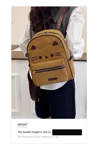 Detail of cute cat face design on vintage ginger yellow backpack for daily commute