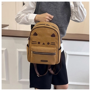 Close-up of caramel retro cat backpack showing matte leather texture and cute animal ears