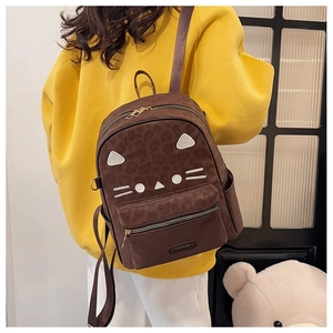 Detail of leopard print cat backpack with cute ear patches on a yellow sweatshirt