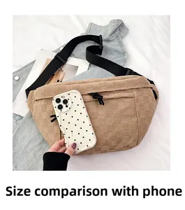 Khaki checkered chest bag size comparison with phone showing plush texture and multiple zippers