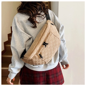 Detail of camel checkered crossbody bag showing woven texture and adjustable strap on back