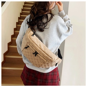Detail view of khaki checkered large crossbody bag with adjustable wide black strap