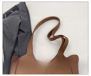 Detail of comfortable wide shoulder strap on a brown matte leather tote bag for women