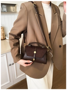 Dettaglio della borsa vintage marrone con fibbia dorata e tracolla regolabile