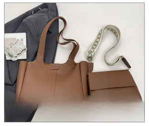 Detailed set of brown tote bag and flap crossbody with bohemian strap on gray surface