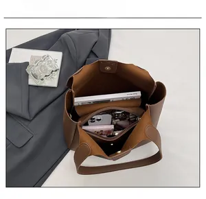 Interior view showing the large capacity and zipper pocket of this dark brown tote bag