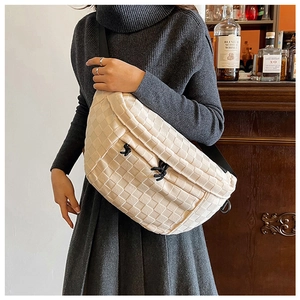 Detail of checkered woven crossbody bag in beige with black adjustable drawstring