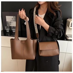 Two-piece set of caramel brown leather tote and crossbody bag with woven strap