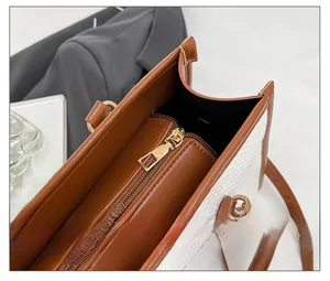Detail view of smooth metal zipper closure and textured woven interior of the tote bag