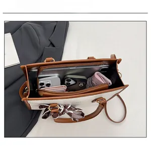 Detail view of large tote bag with interior compartments and spacious storage capacity