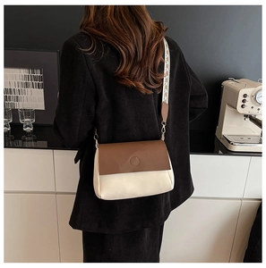 Lifestyle shot of large capacity tote bag with geometric print strap and metal hardware