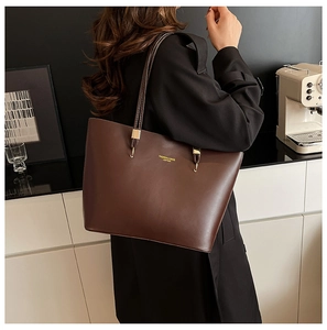 Brown large capacity leather tote bag worn by model showing daily style and size