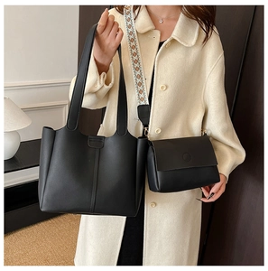 Detail of black large tote and crossbody bag set with patterned ethnic wide strap