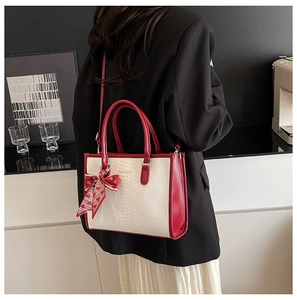 Detail of red and white tote bag with snake skin pattern and heart print silk scarf