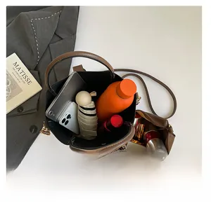 Top view of brown leather bucket bag showing large capacity and inner pouch organizer