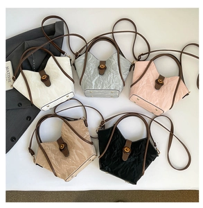 Detailed top view of textured bucket bags in white, silver, pink, beige, and black