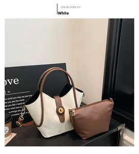 Detail of white marble texture tote bag and brown inner pouch on a stylish desktop
