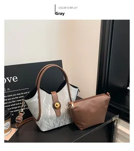 Detail view of silver pleated tote bag set with brown handles and small zip pouch
