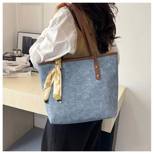 Minimalist large canvas tote bag in light blue with brown leather handles and silk scarf