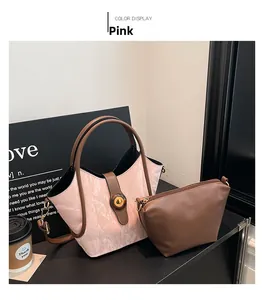 Detail of pink pleated handbag with brown leather straps and matching inner pouch