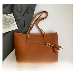 Bruine kunstleren tote bag met goudkleurige letters en een olifant hanger detail