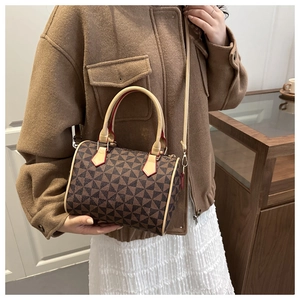 Detailed side view of a Boston style crossbody bag with geometric triangle pattern print
